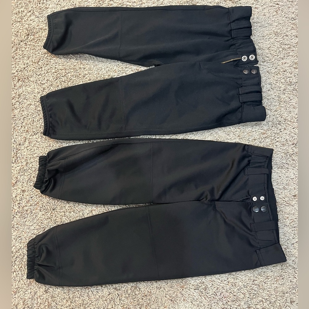 Girls medium softball pants with 2 belts. Worn 1 season. Fits a girl size 10.